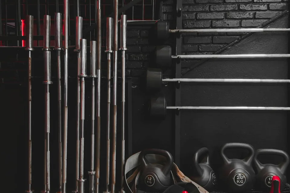Home gym interior with squat rack, free weights, and treadmill