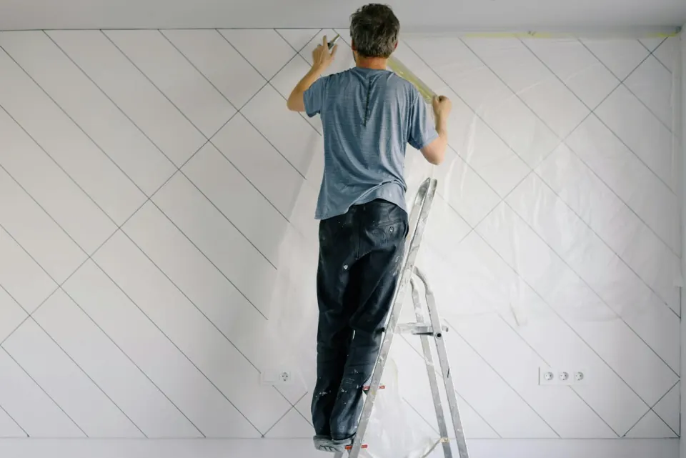 Painter painting an interior wall