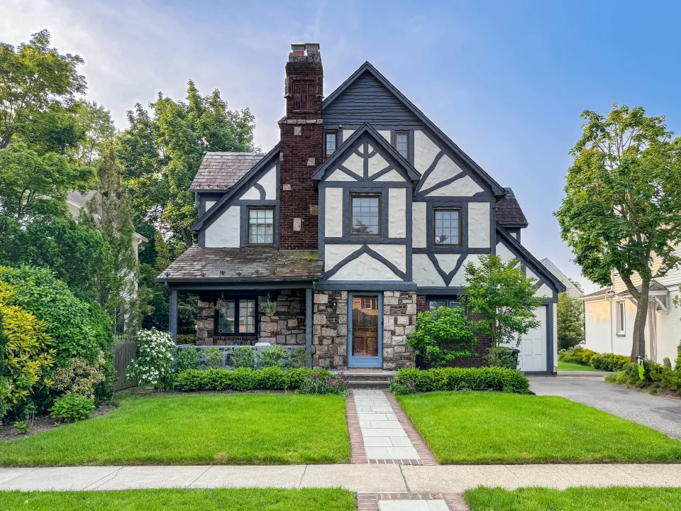 Stucco and half-timber Tudor with a slate roof and brick chimney in Bergen County, NJ